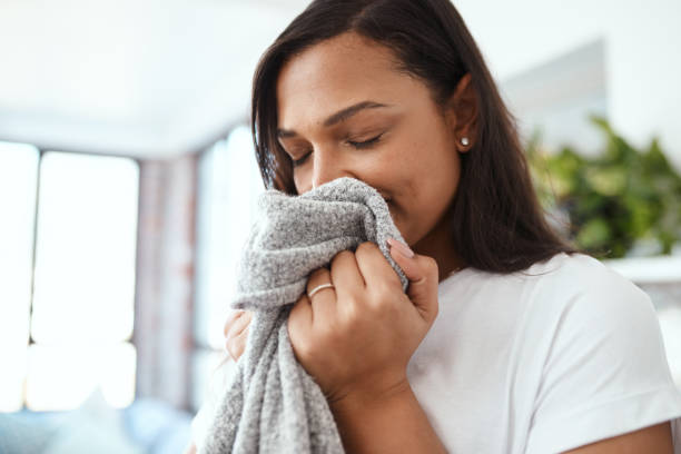 Woman smelling clean clothes